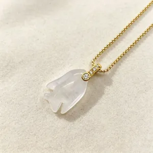 Crystal fish pendant closeup, ocean style carved natural stone jewelry with diamond gold chain