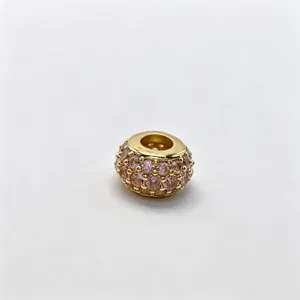 Gold-tone micro-paved pink CZ large-hole charm bead, elegant DIY bracelet jewelry accessory detail.
