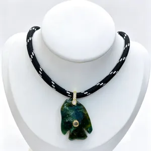 Exquisite carved fish gemstone pendant with sparkling zirconia on black woven cord necklace details.