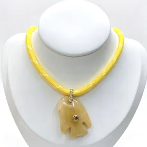 Details of the natural stone tropical fish pendant necklace featuring sparkling zircon inlay accents.
