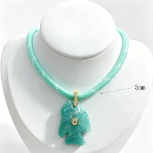 Natural stone tropical fish pendant necklace with blue cord and sparkling zircon details.