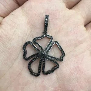 Detailed view of a black gunmetal floral pendant with pavé stones, exquisite jewelry detail.