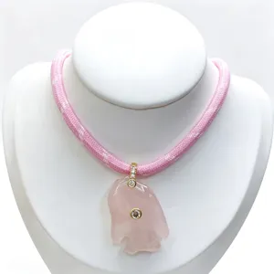 Charming pink woven rope necklace featuring a carved crystal fish pendant with sparkling zircons.