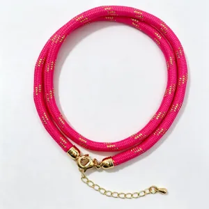 Hot pink polyester braided core cord necklace with gold metallic clasp and extension chain.