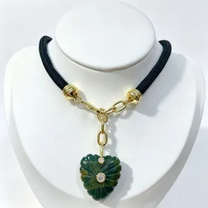 Heart carved natural stone crystal pendant necklace with zircon and black cord for daily wear detail.