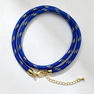 Blue braided cord necklace with gold pattern, lobster clasp and extension chain for DIY crafts.