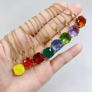Close-up detail of colorful square zircon pendant necklaces showcasing vibrant crystal shades.