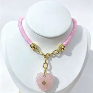 Exquisite pink crystal heart pendant necklace featuring gold hardware and pink rope style.