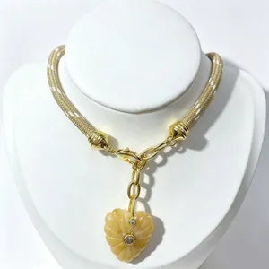 Chic woven cord necklace with gold tone hardware and carved yellow heart stone pendant for women.