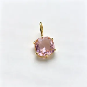 Close-up detail shot of a gorgeous square pink cubic zirconia pendant set in gold brass.