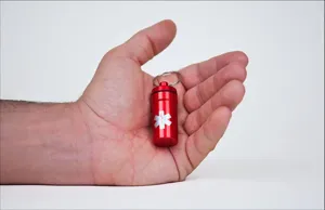 Portable aluminum emergency pill box keychain waterproof pill holder container for outdoor travel.