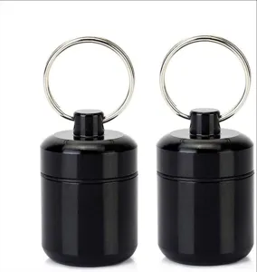 Vue de détail de la boîte à pilules étanche en aluminium noir porte-clés capsule de survie.