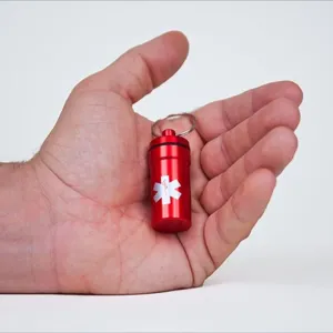 Red aluminum emergency pill bottle keychain waterproof pill holder with medical symbol main view