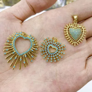 Gold sunburst heart pendant with blue zircon stones, trendy DIY jewelry accessory detail view.