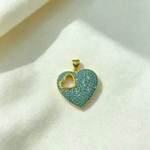 Exquisite gold-plated heart pendant featuring vibrant blue paved zircon stones and a cutout design.