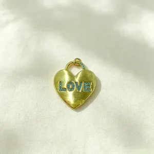 Detailed close-up shot of trendy heart pendant with blue zircon inlay and love text.