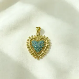 Gold heart pendant with blue micro-paved cubic zirconia, trendy DIY jewelry detail.