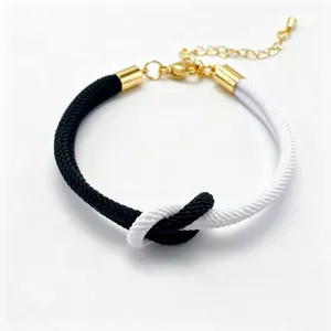 Two-color woven rope bracelet with gold-tone metal components and adjustable extension chain.