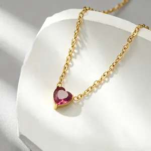 Details of gold plated titanium steel necklace featuring a sparkling pink heart gemstone pendant.