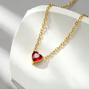 Detail view of the gold-plated heart pendant necklace with radiant red gemstone, elegant style.