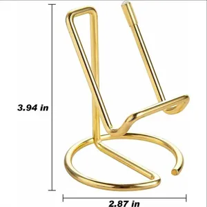 Gold metal phone stand holder, desktop display rack, minimalist modern design details.
