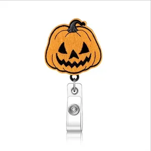 Halloween pumpkin badge reel detail view, retractable felt ID card holder clip accessory.
