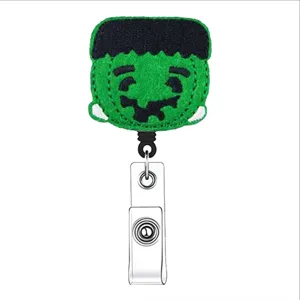 Cute Halloween felt badge reel retractable ID card holder with green monster design.