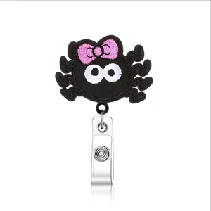 Halloween felt spider badge reel with cute pink bow and retractable clip for nurses ID.