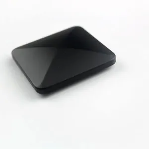 Close-up detail of the black metal kinetic desk toy showing smooth matte surface and sleek shape.