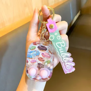 Mignon porte-clés jeu d'eau liquide avec motif donut et pendentif sangle rose.