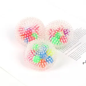 Detail shot of translucent TPR sensory squeeze balls with colorful inner beads and soft spikes.