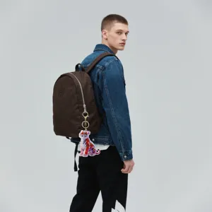 Detailed view of the colorful crystal tiger keychain pendant hanging on a stylish brown backpack.