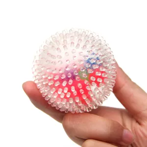 Detail view of clear spiky sensory squeeze toy with colorful beads inside for stress relief.