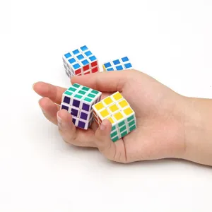 Close-up detail shot of mini puzzle magic cubes held in hand, colorful educational decompression toys