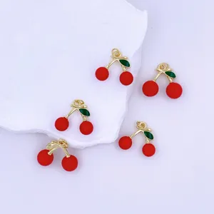 Gold-plated red cherry charm pendant close-up, exquisite enamel DIY jewelry accessory detail shot.