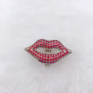Exquisite rhinestone lip-shaped fashion accessory detail view, sparkling pink crystal decor.
