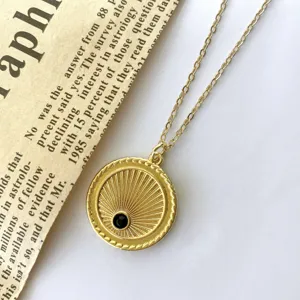 Vintage gold sunburst coin pendant necklace with black zircon detail, elegant jewelry accessory.
