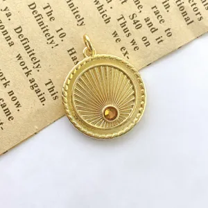 Vintage gold sunray coin pendant charm with embedded amber cubic zirconia for jewelry making.