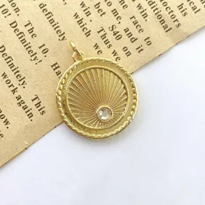 Close-up of vintage gold sunburst coin pendant necklace detail, sparkling cubic zirconia.