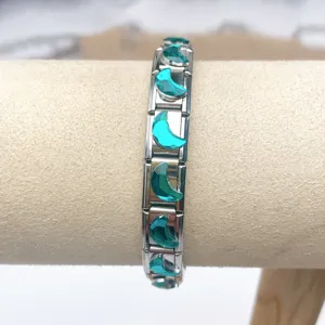 Stainless steel modular charm bracelet with teal moon crystal links for DIY jewelry.