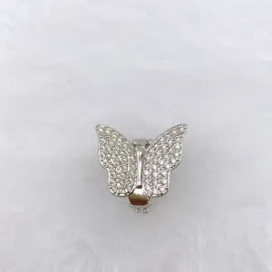 Detailed shot of sparkling butterfly charm with pavé stones for DIY watch strap or bracelet.
