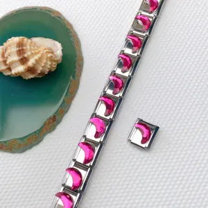 Detail view of stainless steel Italian modular charm bracelet with pink crescent crystal pieces.