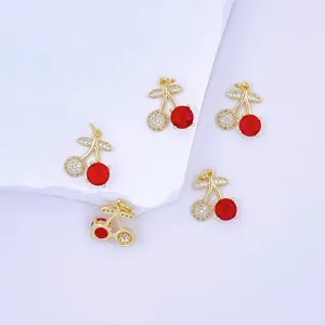 Gold cherry pendant featuring red stone and micro-pave zircon, delicate jewelry accessory detail.