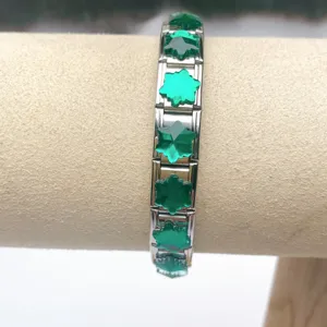 Close-up view of modular stainless steel bracelet links with green crystal charms for DIY styling.