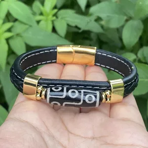 Men retro leather braided bracelet with golden metal buckle and central dzi bead detail.