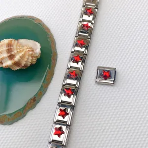 Stainless steel Italian charm bracelet detail featuring red star gemstone modules and DIY links.