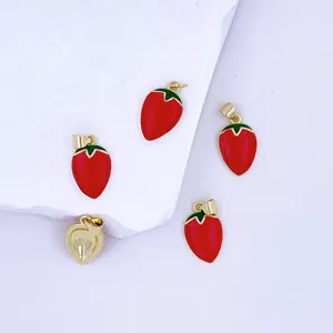 Detail shot of red enamel strawberry metal charms gold plated diy jewelry pendants accessories.