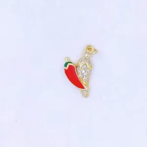 Chili pepper pendant close-up, sparkling zircon inlay, delicate gold metal jewelry detail.