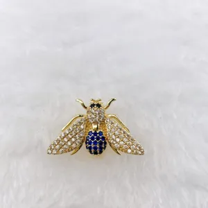 Exquisite crystal bee brooch pin, gold tone metal with sparkling white and blue rhinestones.