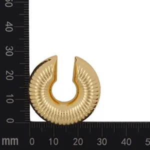 Gold geometric C-shaped clip-on earring with vintage ribbed texture detail close-up